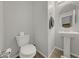 Well-lit powder room featuring tile floors, pedestal sink, and round mirror at 169 Volti Subito Way, Henderson, NV 89011