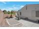 Cozy backyard featuring a small patio area, desert landscaping, and privacy fencing at 1911 Winter Hill St, Las Vegas, NV 89106