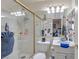 Bathroom featuring a shower-tub combo, white tile, and a mirror reflecting the vanity at 1911 Winter Hill St, Las Vegas, NV 89106