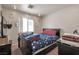 Comfortable bedroom featuring carpet, a ceiling fan, and a large window at 1911 Winter Hill St, Las Vegas, NV 89106