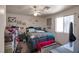 Comfortable bedroom featuring a ceiling fan, large window, and furnished with a queen-size bed at 1911 Winter Hill St, Las Vegas, NV 89106