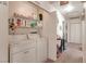 Functional laundry area with washer, dryer, and shelving for storage at 1911 Winter Hill St, Las Vegas, NV 89106