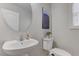 Powder room featuring a pedestal sink, modern toilet, stylish artwork and natural light from a window at 214 Bella Matese Ave, Las Vegas, NV 89183
