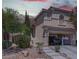 Inviting stucco two-story home with a tile roof and an attached garage at 214 Bella Matese Ave, Las Vegas, NV 89183