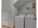 Laundry room with a full-size washer and dryer and wire rack shelving at 214 Bella Matese Ave, Las Vegas, NV 89183