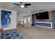 Living area with a modern fireplace, media center, and staircase providing an open and inviting space at 214 Bella Matese Ave, Las Vegas, NV 89183