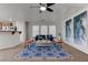 Bright living room with large windows, a modern rug, and stylish furniture providing a cozy atmosphere at 214 Bella Matese Ave, Las Vegas, NV 89183