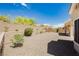 Large backyard with desert landscaping and a retaining wall, perfect for enjoying the serene outdoor space at 2205 Beacon Ridge Dr, Las Vegas, NV 89134