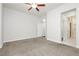Spacious bedroom with plush carpeting, neutral walls, ceiling fan, and access to a walk-in closet at 2205 Beacon Ridge Dr, Las Vegas, NV 89134