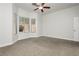 Bedroom with plush carpet, ceiling fan, bright walls, and windows offering outdoor views at 2205 Beacon Ridge Dr, Las Vegas, NV 89134