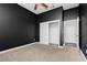 Bedroom featuring a ceiling fan, plush carpet, dark colored walls, and a closet with shelving at 2205 Beacon Ridge Dr, Las Vegas, NV 89134