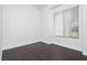 Cozy bedroom with modern dark wood flooring, bright walls, and natural light at 2205 Beacon Ridge Dr, Las Vegas, NV 89134