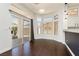 Bright dining area with dark wood floors, large windows, and sliding glass doors leading to the patio at 2205 Beacon Ridge Dr, Las Vegas, NV 89134