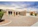 A single-story home with desert landscaping and a tile roof, featuring neutral colors at 2205 Beacon Ridge Dr, Las Vegas, NV 89134