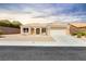 Charming single-story home featuring a two-car garage, desert landscaping, and a tile roof at 2205 Beacon Ridge Dr, Las Vegas, NV 89134