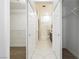 Hallway featuring white closet doors, tile flooring, and access to a bathroom with shower at 2205 Beacon Ridge Dr, Las Vegas, NV 89134