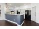 Modern kitchen with white cabinets, granite countertops, stainless steel appliances, and dark wood flooring at 2205 Beacon Ridge Dr, Las Vegas, NV 89134