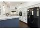 Bright kitchen featuring granite countertops, white cabinets, stainless steel appliances, and dark wood floors at 2205 Beacon Ridge Dr, Las Vegas, NV 89134