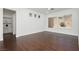 Spacious living room with dark wood flooring, three windows, and recessed lighting at 2205 Beacon Ridge Dr, Las Vegas, NV 89134