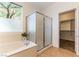 Bright bathroom with soaking tub, framed shower, tile floors, and walk-in closet at 2357 Aztec Ruin Way, Henderson, NV 89044