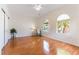 Primary bedroom with hardwood floors and natural light from arched windows at 2357 Aztec Ruin Way, Henderson, NV 89044