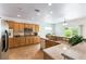 Bright kitchen with tile floors, stainless steel microwave, light wood cabinets, and granite countertops at 2357 Aztec Ruin Way, Henderson, NV 89044