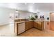 Bright kitchen with tile floors, white dishwasher, light wood cabinets, and granite countertops at 2357 Aztec Ruin Way, Henderson, NV 89044