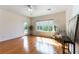 Bright living room with hardwood floors, backyard views, white ceiling fan, and neutral paint at 2357 Aztec Ruin Way, Henderson, NV 89044