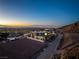 Aerial view of a modern home at sunset with city views and mountain backdrop at 25 Rockstream Dr, Henderson, NV 89012