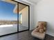 View from inside to a large balcony with city views, floor to ceiling sliding glass doors and modern decor at 25 Rockstream Dr, Henderson, NV 89012