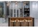 Stylish bar area with sleek barstools, modern lighting, and a display of various spirits and wine at 25 Rockstream Dr, Henderson, NV 89012