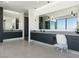 Bathroom with dual vanities with modern fixtures and large mirrors, pendant lighting, and tile flooring at 25 Rockstream Dr, Henderson, NV 89012
