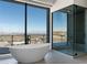 Bathroom with standalone tub and luxurious glass enclosed shower overlooking city view at 25 Rockstream Dr, Henderson, NV 89012
