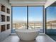 Modern bathroom features a standalone tub with a view of the city skyline at 25 Rockstream Dr, Henderson, NV 89012
