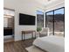 Bright bedroom with modern design, a desk and chair, and a large window with mountain views at 25 Rockstream Dr, Henderson, NV 89012