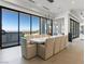 Elegant dining area features a long dining table, city views, and seamless indoor-outdoor living at 25 Rockstream Dr, Henderson, NV 89012