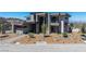 Contemporary two-story home with desert landscaping, balcony, and mountain views at 25 Rockstream Dr, Henderson, NV 89012
