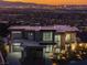 Stunning exterior view of the modern home, showcasing clean lines and expansive windows with city view at 25 Rockstream Dr, Henderson, NV 89012