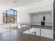 Hallway with wood floors, modern railing and mountain views through large windows at 25 Rockstream Dr, Henderson, NV 89012