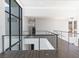 Hallway with modern staircase and large window views of the mountains at 25 Rockstream Dr, Henderson, NV 89012