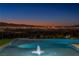 Beautiful infinity pool overlooking the city skyline at dusk at 25 Rockstream Dr, Henderson, NV 89012