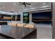 Spacious kitchen and living area with comfortable seating and a view of the city lights at night at 25 Rockstream Dr, Henderson, NV 89012