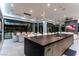 Open-concept kitchen with a large island, sleek countertops, and dining area with city views at 25 Rockstream Dr, Henderson, NV 89012