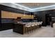 Modern kitchen with black and wood cabinetry, an island with bar seating, and pendant lighting at 25 Rockstream Dr, Henderson, NV 89012