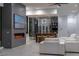 Stylish living area with modern fireplace, wine display, and comfortable white seating at 25 Rockstream Dr, Henderson, NV 89012