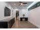 Open living area with built-in bar and cabinetry, view to additional room and hallway at 25 Rockstream Dr, Henderson, NV 89012