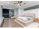 Spacious bedroom with a ceiling fan, ensuite seating, and a window with stunning city views at 25 Rockstream Dr, Henderson, NV 89012