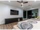 Spacious bedroom with a ceiling fan, ensuite seating, and a window with stunning city views at 25 Rockstream Dr, Henderson, NV 89012