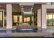 Luxurious infinity pool with integrated waterfall and outdoor seating area at 25 Rockstream Dr, Henderson, NV 89012