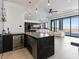 Open concept wet bar with beverage center, island seating, and stunning city view at 25 Rockstream Dr, Henderson, NV 89012